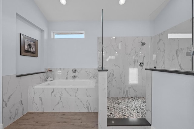 bathroom with a marble finish shower and a bath