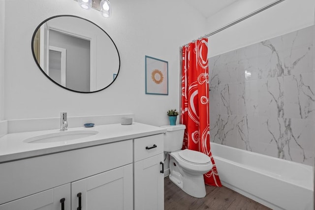full bathroom with toilet, wood finished floors, vanity, and shower / bath combo