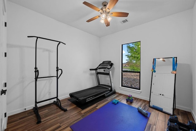 workout room with baseboards, visible vents, wood finished floors, and a ceiling fan