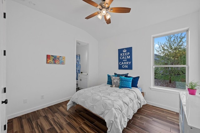 bedroom with baseboards, wood finished floors, vaulted ceiling, and multiple windows
