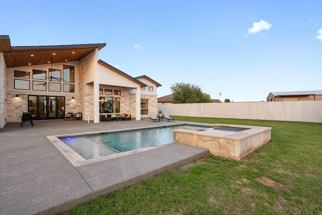 view of swimming pool with fence, a patio, a fenced in pool, an in ground hot tub, and a yard