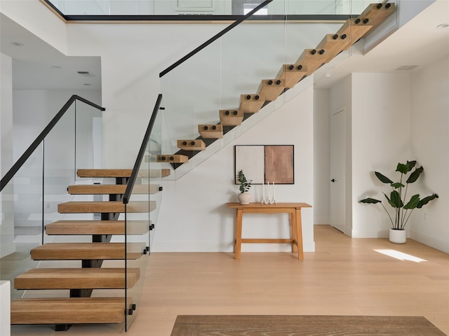 411 Krebs, Austin, TX 78704 - staircase with wood finished floors, baseboards, and a towering ceiling