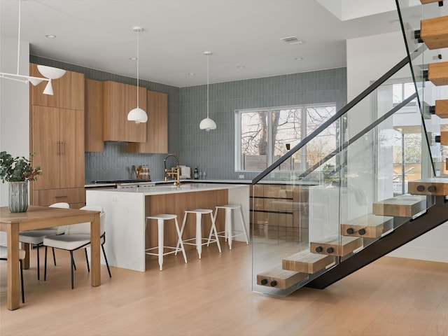 411 Krebs, Austin, TX 78704 - kitchen featuring modern cabinets, plenty of natural light, and brown cabinets