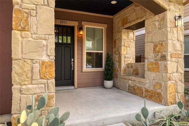 2513 Moreno St, Austin, TX 78723 - view of exterior entry with stone siding and a porch