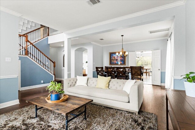 1019 Lone Buck Pass, Cedar Park, TX 78613 - living area with wood finished floors, a chandelier, stairs, arched walkways, and crown molding