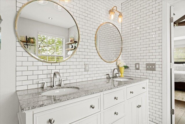 1019 Lone Buck Pass, Cedar Park, TX 78613 - ensuite bathroom featuring double vanity and tasteful backsplash
