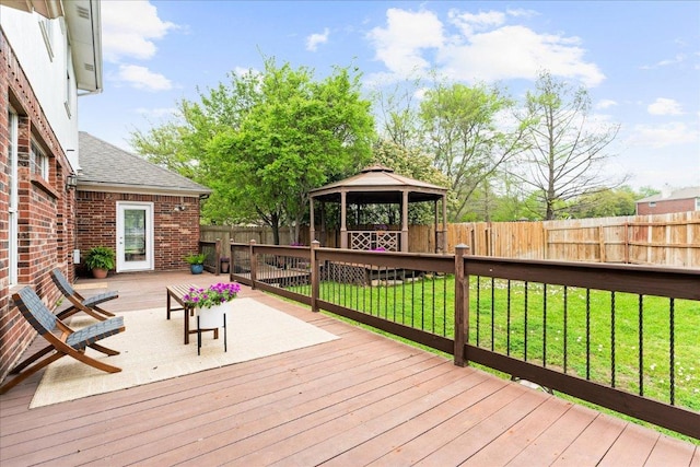 wooden terrace with a gazebo, a fenced backyard, and a lawn