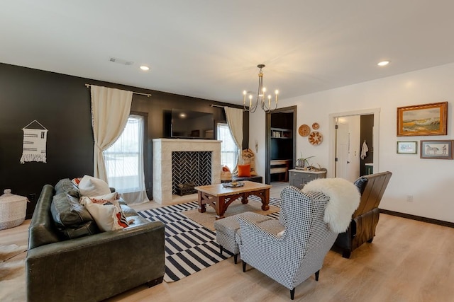 6810 River Oaks Dr, Kingsland, TX 78639 - living area featuring a chandelier, light wood-type flooring, and a fireplace with flush hearth