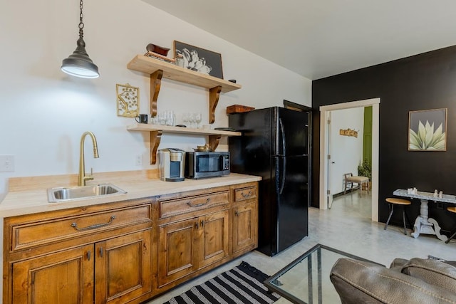 6810 River Oaks Dr, Kingsland, TX 78639 - kitchen featuring freestanding refrigerator, open shelves, brown cabinets, hanging light fixtures, and light countertops