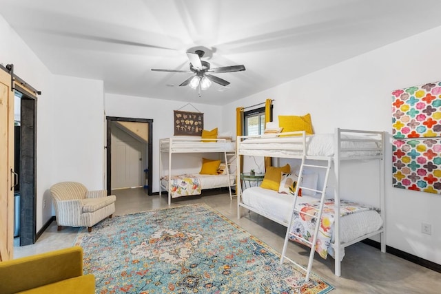 6810 River Oaks Dr, Kingsland, TX 78639 - bedroom with a barn door, finished concrete flooring, and a ceiling fan