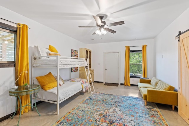 6810 River Oaks Dr, Kingsland, TX 78639 - bedroom featuring a barn door, concrete flooring, and ceiling fan