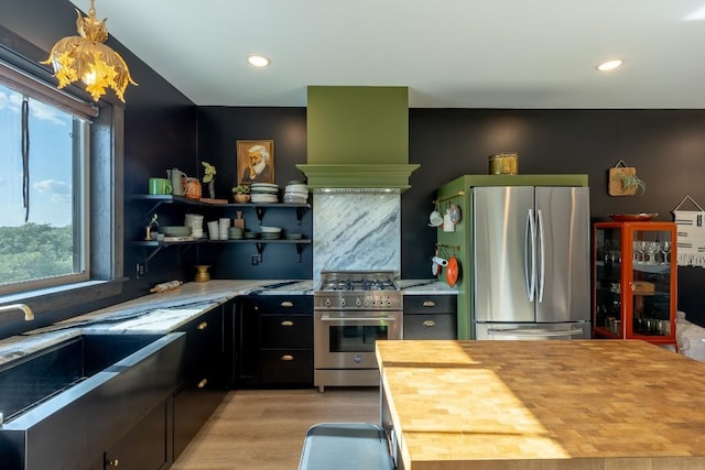 6810 River Oaks Dr, Kingsland, TX 78639 - kitchen with appliances with stainless steel finishes, wood counters, healthy amount of natural light, light wood-type flooring, and recessed lighting