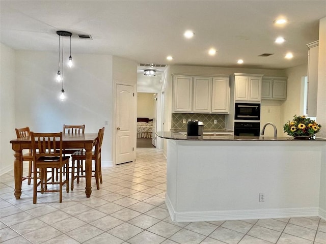 12452 Fairfax Ridge Pl, Austin, TX 78738 - kitchen with wall oven, built in microwave, dark countertops, decorative backsplash, and recessed lighting
