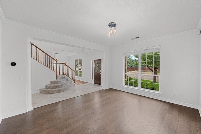 12452 Fairfax Ridge Pl, Austin, TX 78738 - foyer with wood finished floors, stairway, ornamental molding, and baseboards