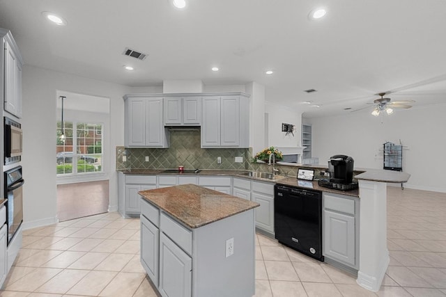 12452 Fairfax Ridge Pl, Austin, TX 78738 - kitchen with black appliances, a peninsula, decorative backsplash, a ceiling fan, and light tile patterned floors