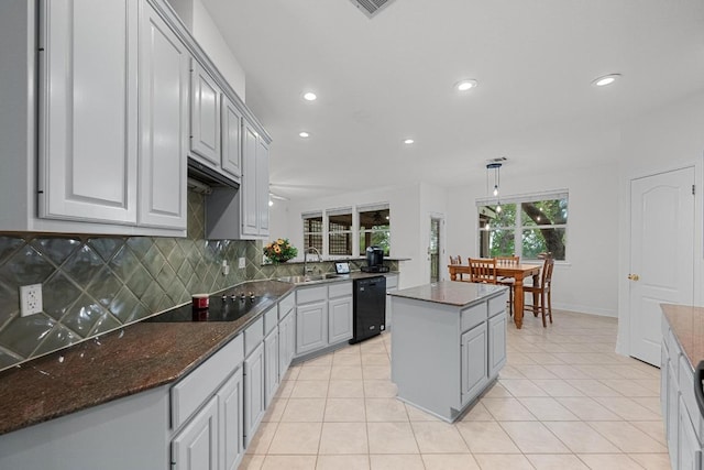 12452 Fairfax Ridge Pl, Austin, TX 78738 - kitchen featuring black appliances, a sink, recessed lighting, decorative backsplash, and a center island