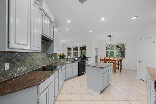 12452 Fairfax Ridge Pl, Austin, TX 78738 - kitchen featuring black appliances, recessed lighting, decorative backsplash, a kitchen island, and light tile patterned flooring