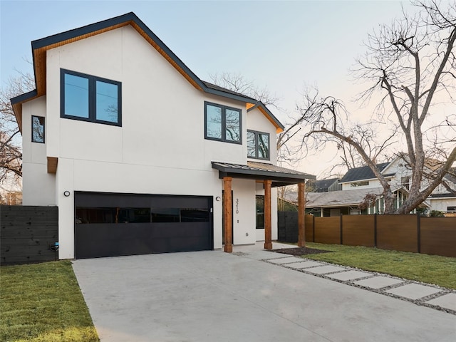 3210 Thompson, Austin, TX 78702 - modern home with stucco siding, an attached garage, concrete driveway, and metal roof
