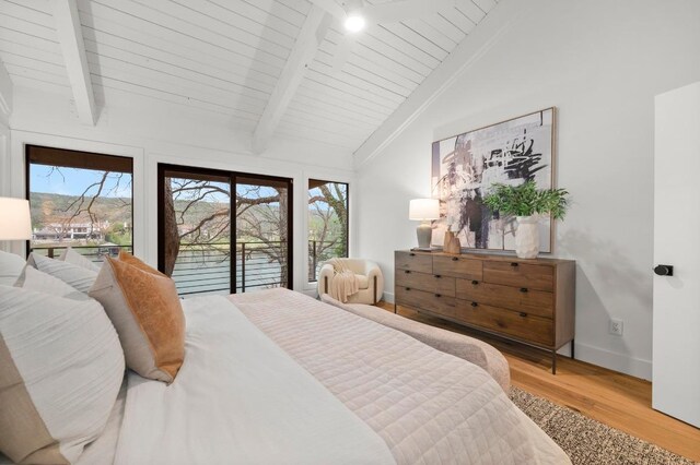 bedroom with multiple windows, lofted ceiling with beams, access to outside, and light wood-style floors