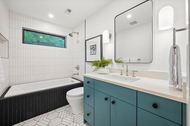 full bathroom featuring bathtub / shower combination, visible vents, vanity, and toilet