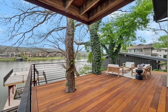 deck with an outdoor hangout area and a water view