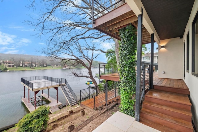 dock area with stairway and a water view