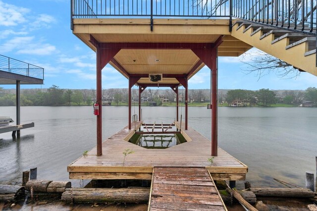 dock area featuring a water view and boat lift