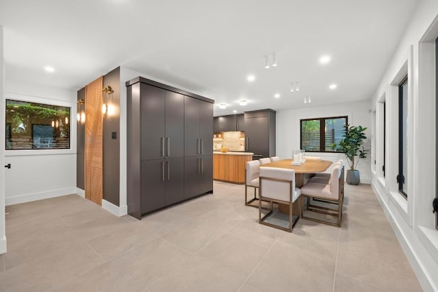 dining room with baseboards, recessed lighting, and light tile patterned floors