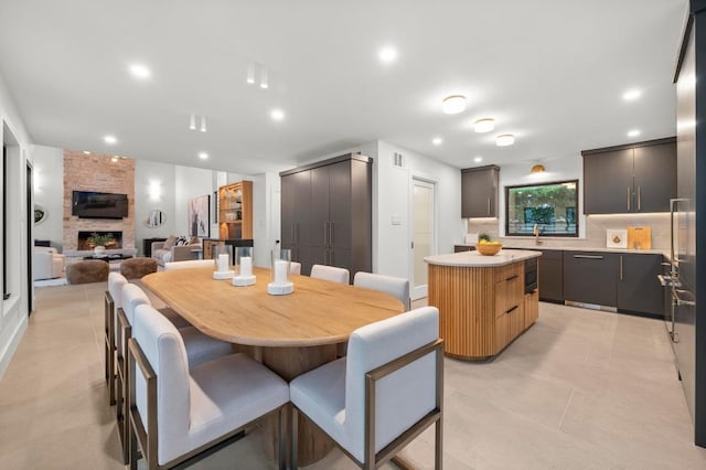 dining space featuring visible vents, a large fireplace, recessed lighting, and light tile patterned floors