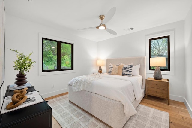bedroom with baseboards, multiple windows, and visible vents