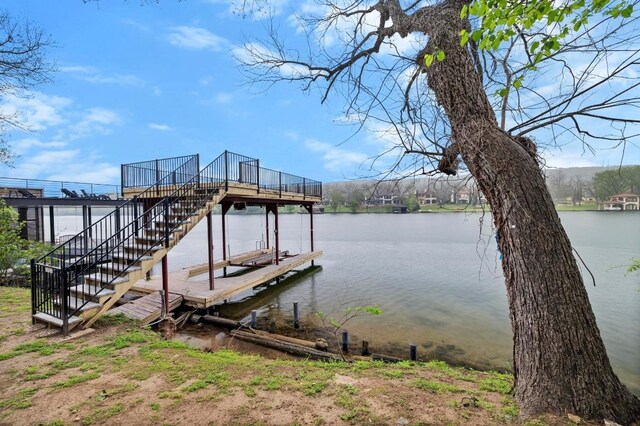 view of dock featuring stairs and a water view