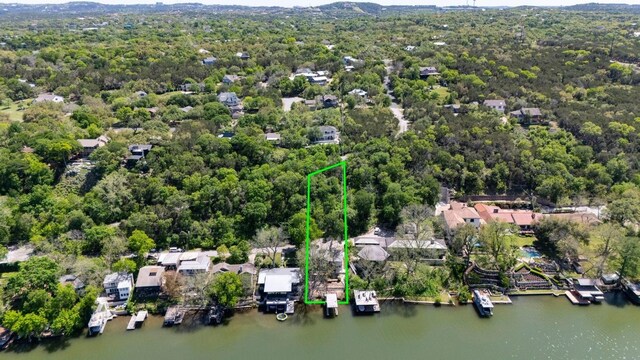 1606 Ski Slope Dr, Austin, TX 78733 - aerial view of property and surrounding area featuring property parcel outlined, a large body of water, and a heavily wooded area