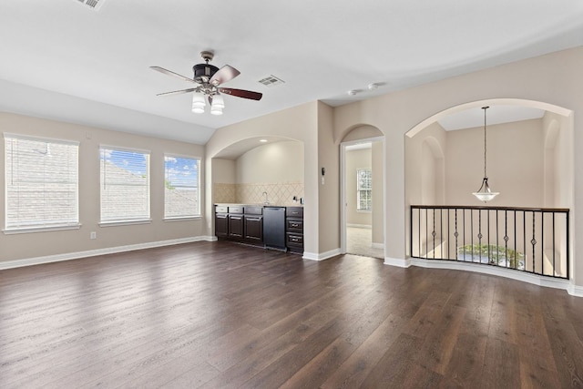 3312 Cortes Pl, Round Rock, TX 78665 - unfurnished living room with a ceiling fan, dark wood-style floors, and arched walkways