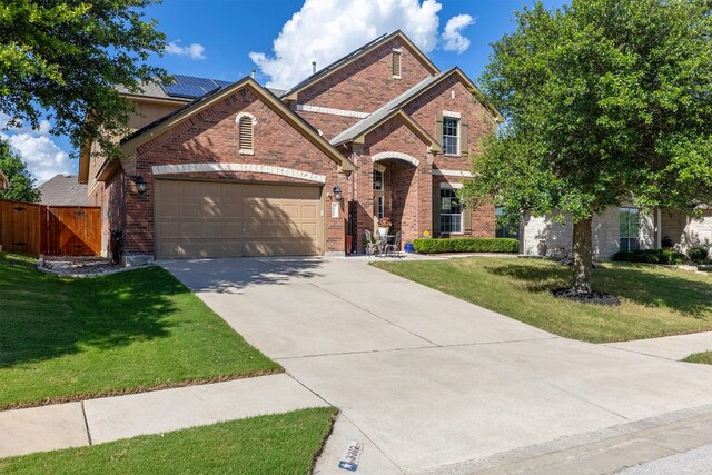 3312 Cortes Pl, Round Rock, TX 78665 - view of front of home featuring brick siding, driveway, a garage, and a gate