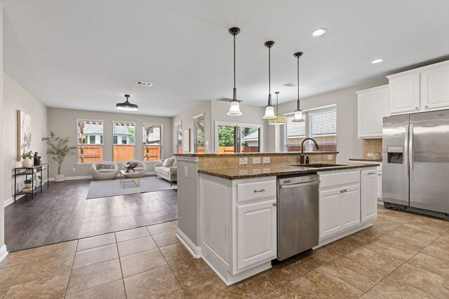 3312 Cortes Pl, Round Rock, TX 78665 - kitchen with stainless steel appliances, healthy amount of natural light, open floor plan, a kitchen island with sink, and recessed lighting