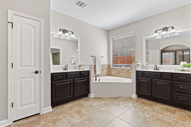 3312 Cortes Pl, Round Rock, TX 78665 - bathroom featuring two vanities and a garden tub