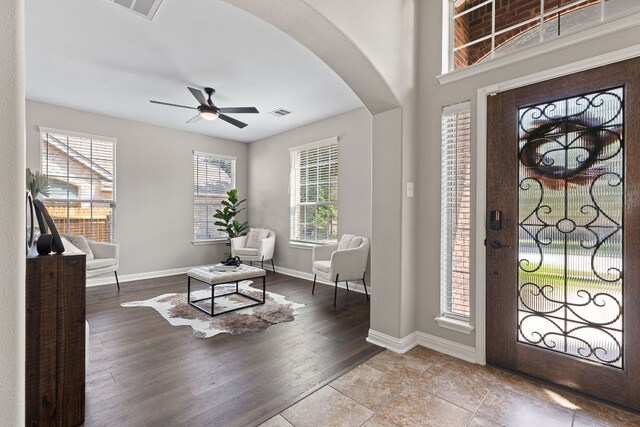 3312 Cortes Pl, Round Rock, TX 78665 - foyer entrance with arched walkways, ceiling fan, and wood finished floors