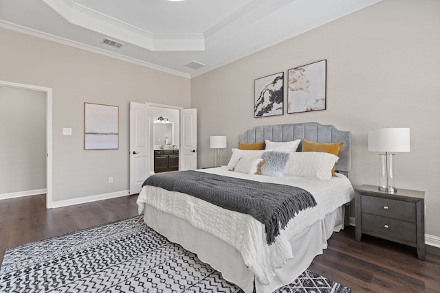 3312 Cortes Pl, Round Rock, TX 78665 - bedroom featuring a raised ceiling, wood finished floors, ornamental molding, and connected bathroom