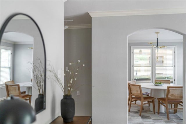 2210 Meadowbrook Dr, Austin, TX 78703 - dining area featuring arched walkways, ornamental molding, and a chandelier