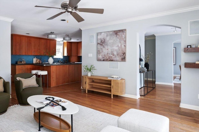 2210 Meadowbrook Dr, Austin, TX 78703 - living area featuring wood finished floors, ceiling fan, arched walkways, and crown molding