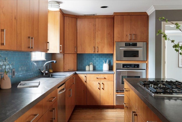 2210 Meadowbrook Dr, Austin, TX 78703 - kitchen featuring appliances with stainless steel finishes, light wood-type flooring, backsplash, brown cabinetry, and dark countertops