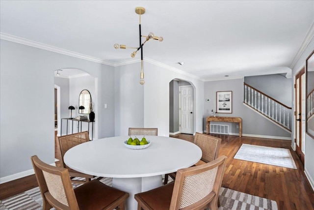 2210 Meadowbrook Dr, Austin, TX 78703 - dining space featuring arched walkways, stairway, wood finished floors, ornamental molding, and a chandelier