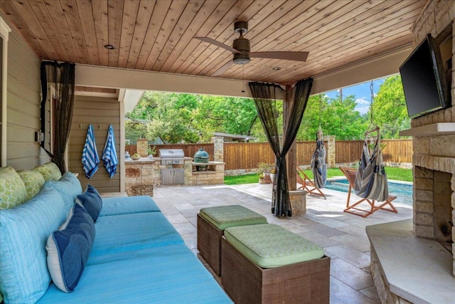2210 Meadowbrook Dr, Austin, TX 78703 - fenced backyard featuring exterior kitchen, a patio area, and a ceiling fan