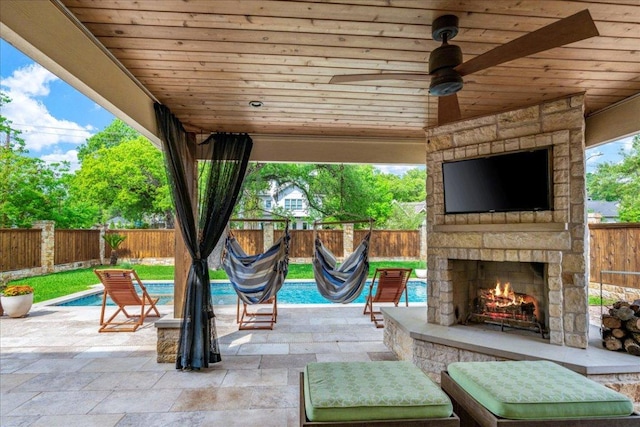 2210 Meadowbrook Dr, Austin, TX 78703 - fenced backyard with an outdoor stone fireplace and a patio area