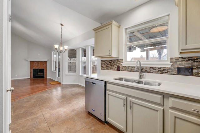 214 Crystal Knoll Blvd, Georgetown, TX 78626 - kitchen with dishwasher, vaulted ceiling, tasteful backsplash, light countertops, and light tile patterned floors
