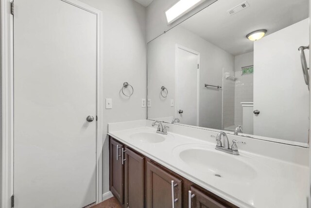 214 Crystal Knoll Blvd, Georgetown, TX 78626 - bathroom featuring double vanity and tiled shower