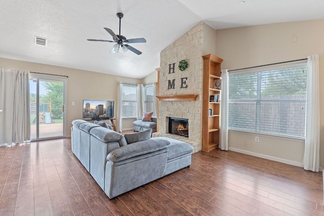 198 Prairie Springs Loop, Georgetown, TX 78626 - living area with a fireplace, visible vents, a ceiling fan, and dark wood-style flooring