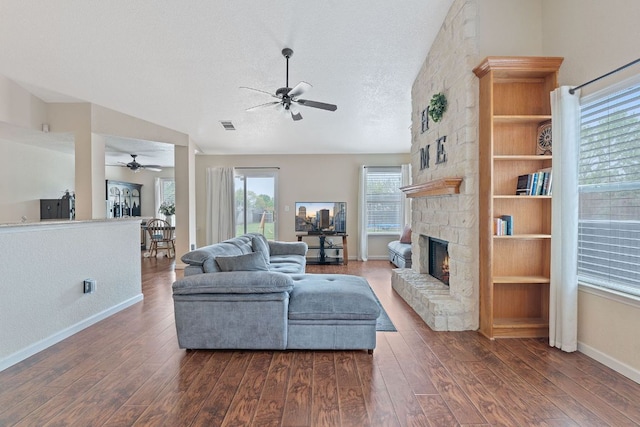 198 Prairie Springs Loop, Georgetown, TX 78626 - living room featuring visible vents, baseboards, wood finished floors, ceiling fan, and a fireplace
