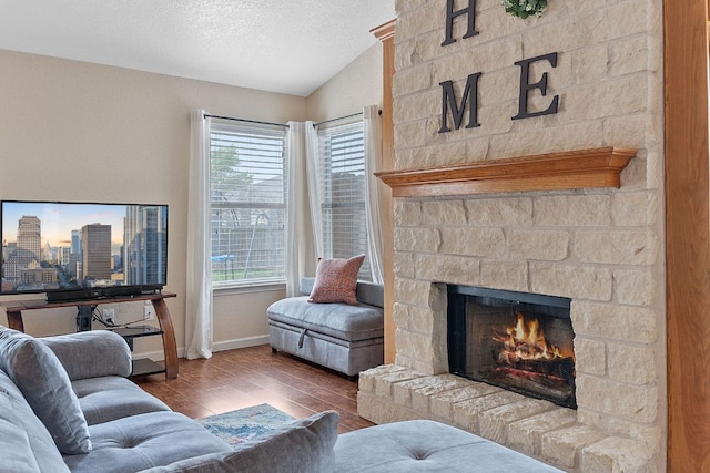 198 Prairie Springs Loop, Georgetown, TX 78626 - living area with a wealth of natural light, vaulted ceiling, wood finished floors, and a fireplace