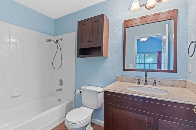 198 Prairie Springs Loop, Georgetown, TX 78626 - bathroom featuring toilet, shower / bathtub combination, baseboards, a textured wall, and vanity